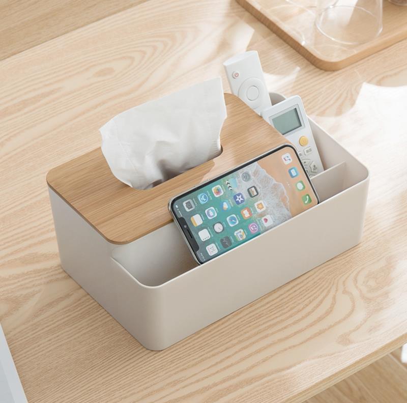 Bamboo-topped tissue and essentials organizer shown with phone and remotes