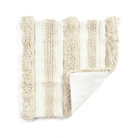 Close-up of the textured tufted cotton design in ivory and neutral tones