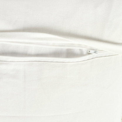 Ivory and neutral tufted cotton pillow cover in a layered home decor setting